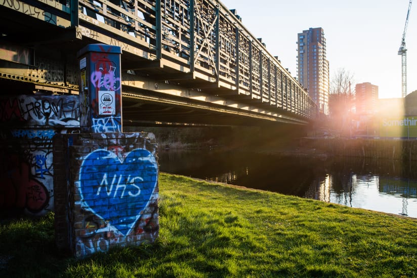 Bow Locks Railway bridge, with a blue graffiti heart reading "NHS"